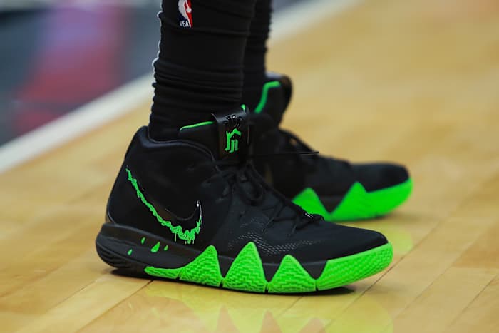 Black and green Nike Kyrie 4 shoes.